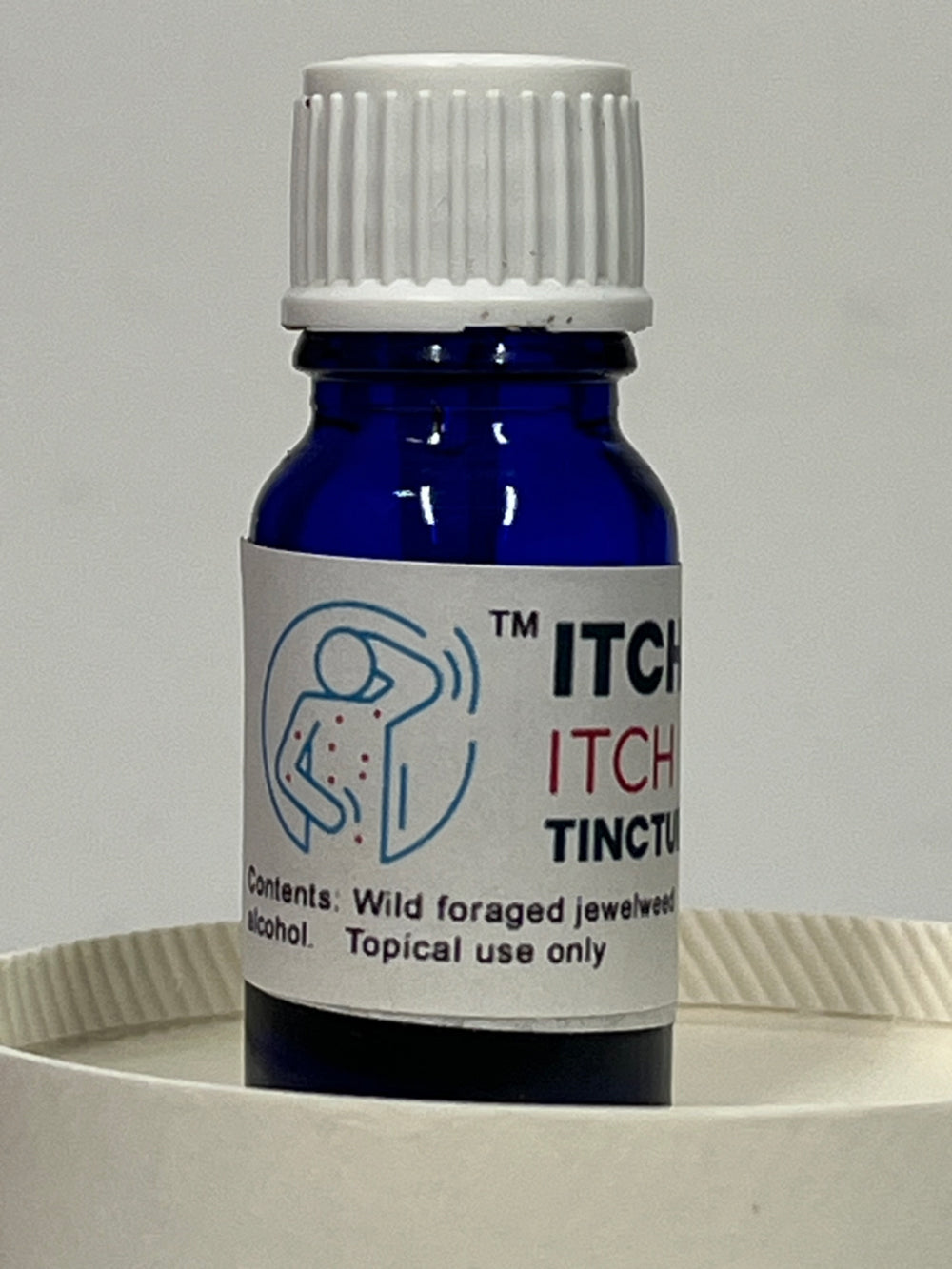 Bottle of 'ITCH GONE ITCH RELIEF TINCTURE' with a white label on a gray background
