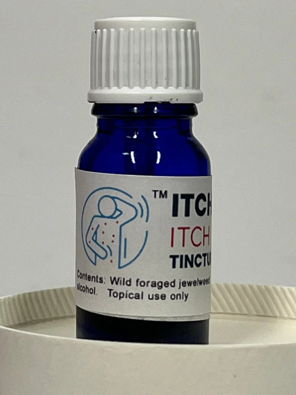 Blue bottle labeled 'ITCH GONE ITCH RELIEF TINCTURE' with a white cap on a light gray background